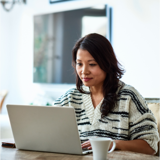 A woman using a laptop to review variable annuity investment options.