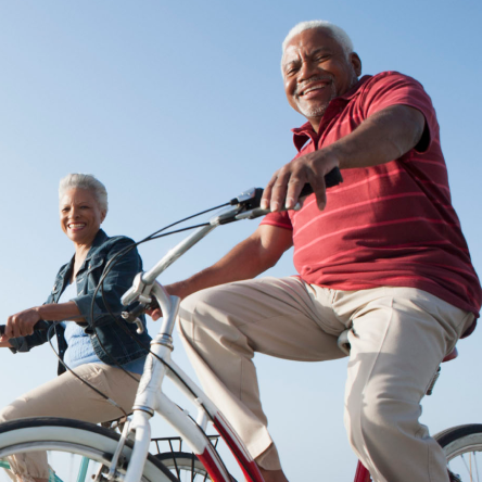 A man and a woman depicting the ideal Protective Income Builder indexed annuity clients, enjoy a bike ride.