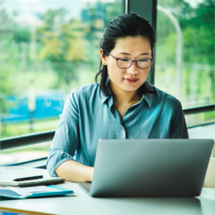 A financial professional reads about updates to Protective's accelerated underwriting program on her laptop.
