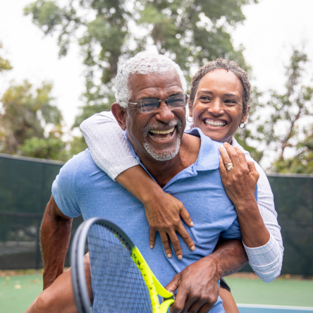 Couple enjoying time together on a tennis court.