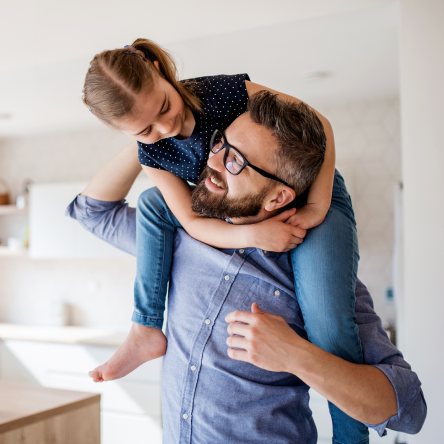 A father enjoying time with his daughter knowing his family is protected with term life insurance.
