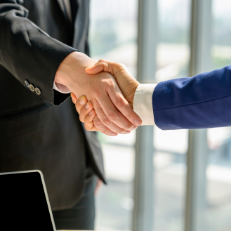 Two financial professionals shaking hands