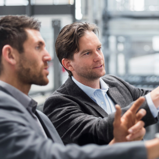 Two professional discussing how to use Protective Executive 10-Year Term to carve out a life insurance benefit for leaders of a firm.