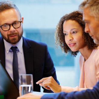 A financial professional showing two health care executives how Protective Executive 10-Year Term can replace a competitor plan.
