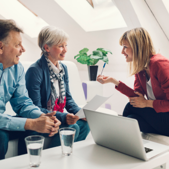 A financial professional showing a retired husband and wife the benefits of term life insurance