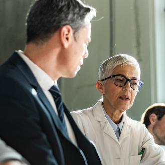 Investment professionals discussing how to protect their firm's key employees with Protective Executive UL.