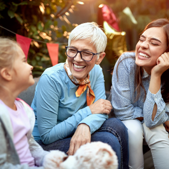 Grandmother sharing a laugh with her grandchildren.