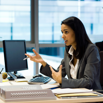 A financial professional discussing services the bank offers with a customer.