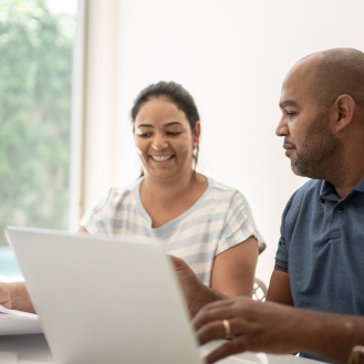 Two people discussing permanent life insurance options. 