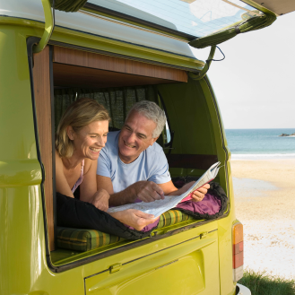 couple relaxing on a road trip after purchasing an indexed annuity for balanced growth and protection.