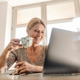 Woman using her laptop to research information on low-risk fixed annuities
