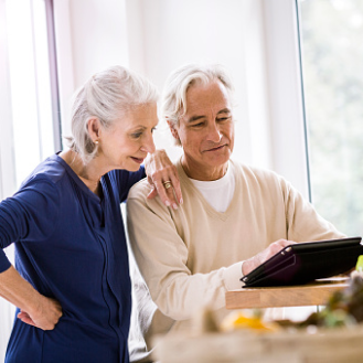 Husband and wife reviewing information about a variable annuity that fits their risk-tolerance, growth-focused retirement savings objectives.