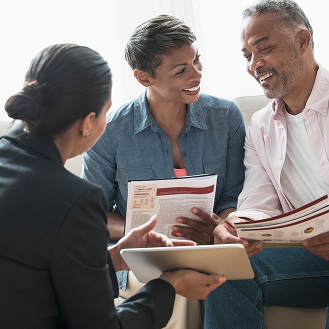 Financial professional going over details of Protective Aspirations variable annuity solutions with a couple.