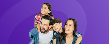 A smiling mother, father and their two children.