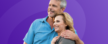 A retired couple smiling.