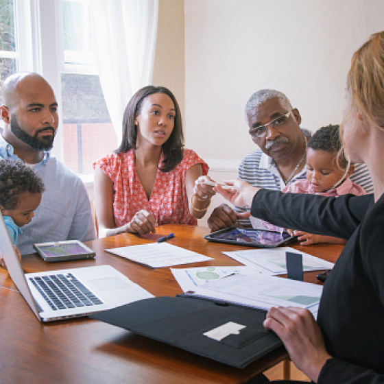 A client and her multi-generational family gets information from a financial professional on how to access her Protective MyAccount.