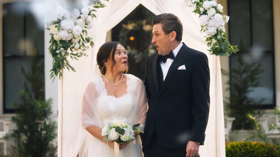 A video still image of an excited couple at their wedding.