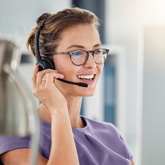 A woman with a headset providing support services for financial professionals.