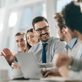 A group of excited executives in a meeting.