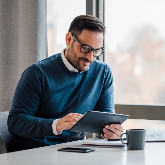 A financial professional reviewing the ProClassic Legacy UL producer guide on a tablet.