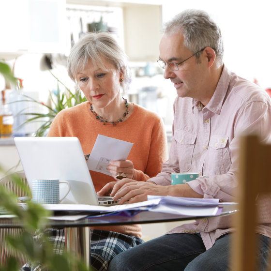 A couple reviewing the Protective® Income Provider option to determine when and how they want their insurance policy's death benefit to be paid.