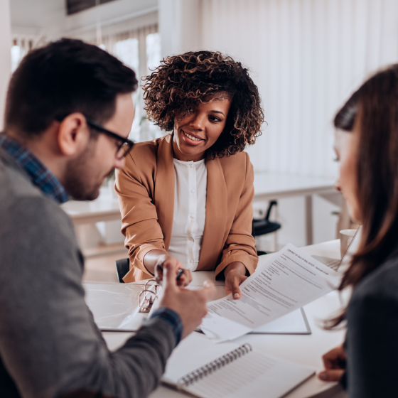 A financial professional presenting the benefits of indexed universal life insurance to a husband and wife