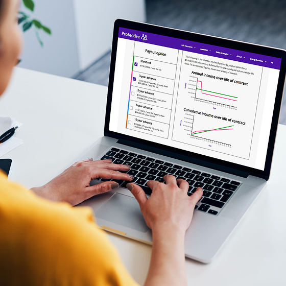 A financial professional uses the income calculator on a laptop.