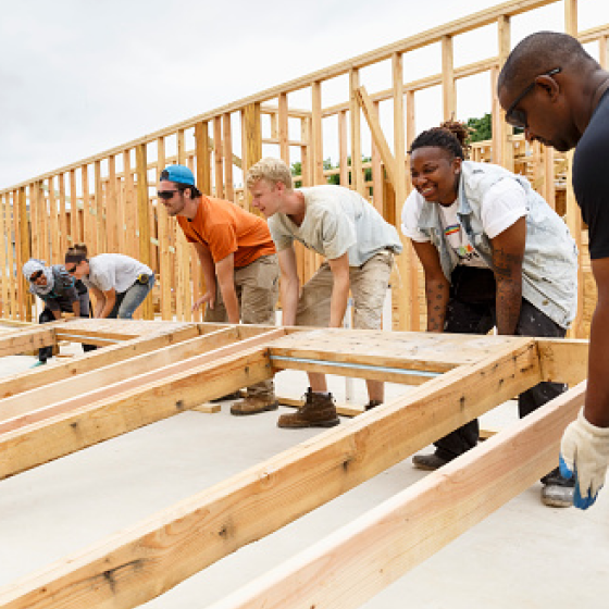 Volunteers building a house representing how Protective can help provide charitable giving strategies.