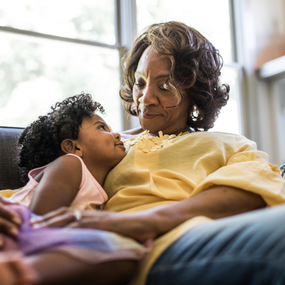 A grandmother embracing her granddaughter knowing her financial wishes are protected with Protective ProClassic Legacy UL.
