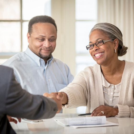 A financial professional shaking hands with clients after purchasing Protective Indexed Choice UL universal life insurance.