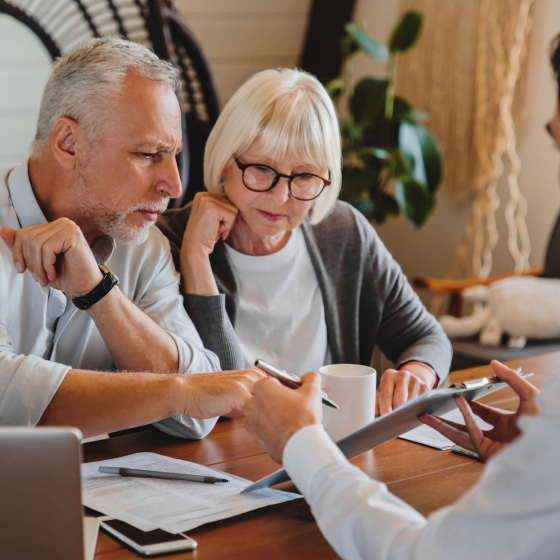 A married couple reviewing life insurance options with their financial professional.