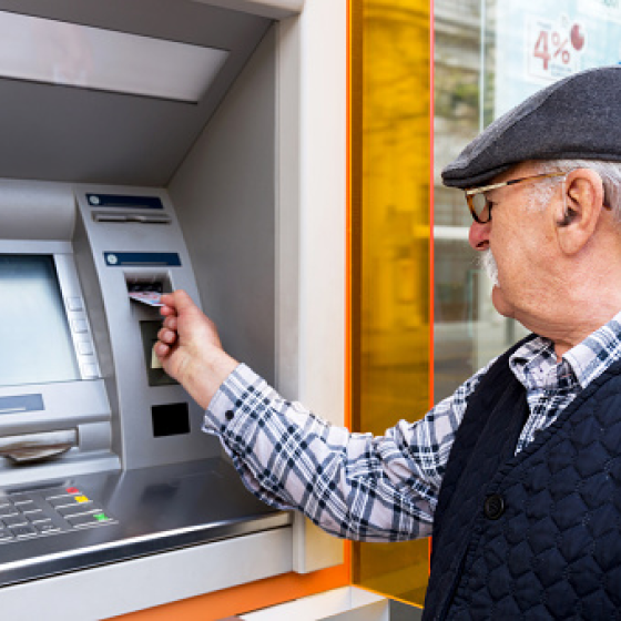 A man using an ATM to access cash.