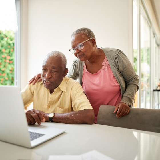 A husband and wife using a computer to review information about Protective Survivor UL.
