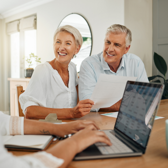A couple smiling while discussing Protective Smart Saver fixed annuity with a financial professional.