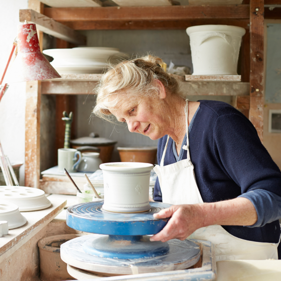Woman, who represents the ideal ProPayer Immediate Annuity client, works in her pottery studio.