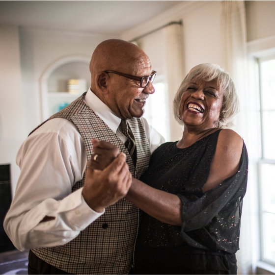 Couple dancing together in their home