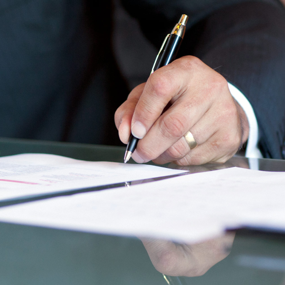 Client signing estate planning documents.