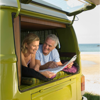 couple relaxing on a road trip after purchasing an indexed annuity for balanced growth and protection.