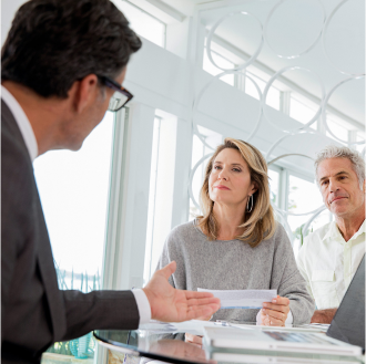 Customers talking to a bank employee.