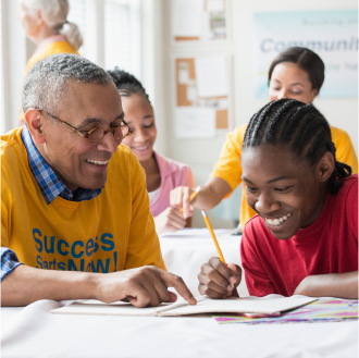 A volunteer helping a student as part of his charitable giving plan.