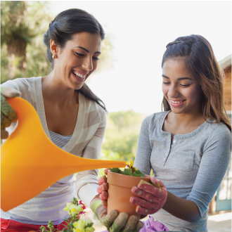 A woman gardening with her young daughter, knowing her family is protected with Protective Custom Choice universal life insurance.