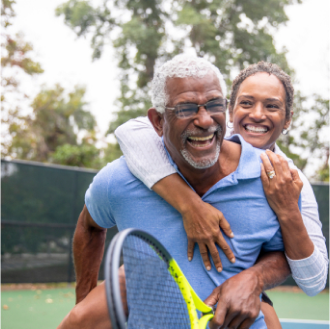 Couple enjoying guaranteed lifetime income on a tennis court