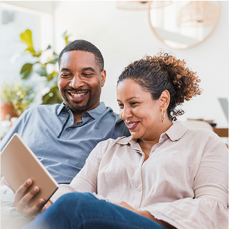 A couple reviewing their life insurance benefits on a tablet.