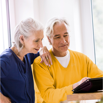 Husband and wife reviewing information about a variable annuity that fits their risk-tolerance, growth focused retirement savings objectives.
