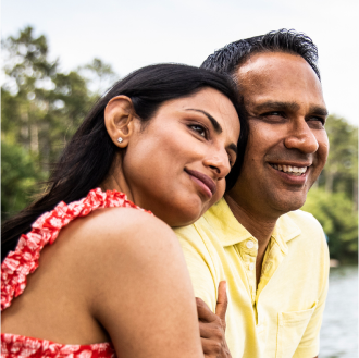 A young couple embracing knowing their financial future is protected.