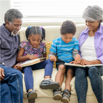 A couple enjoying time with their grandchildren knowing they have a strong legacy solution in place.