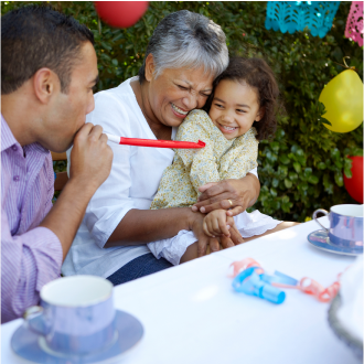 A grandmother celebrating their granddaughter's birthday, knowing her family is protected with Protective Lifetime Assurance universal life insurance.