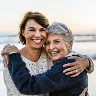 Mother enjoys a walk on the beach with her daughter, confident her retirement assets are secure thanks to Protective Series Balance annuity guarantees.